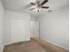 Bedroom featuring a ceiling fan, closet, and entrance to another room at 714 Golden Elm Dr, Apopka, FL 32703