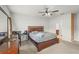 Bedroom with ceiling fan, striped bedding, and en-suite bathroom access at 714 Golden Elm Dr, Apopka, FL 32703