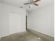 A bright bedroom features a ceiling fan, closet, and neutral decor at 714 Golden Elm Dr, Apopka, FL 32703