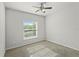 Sunlit bedroom with a large window offering neighborhood views at 714 Golden Elm Dr, Apopka, FL 32703