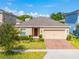 Charming single-Gathering home with well-kept lawn, brick-paved driveway, and a two-car garage, offering great curb appeal at 714 Golden Elm Dr, Apopka, FL 32703