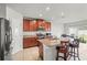 Contemporary kitchen with granite counters, stainless steel appliances, and breakfast bar seating at 714 Golden Elm Dr, Apopka, FL 32703