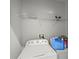 Bright laundry room with washer, dryer, and overhead shelf at 714 Golden Elm Dr, Apopka, FL 32703