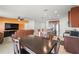 Open concept kitchen, dining, and living area with tile floors and stainless appliances at 714 Golden Elm Dr, Apopka, FL 32703