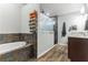 Luxurious bathroom featuring a soaking tub, glass enclosed shower, and granite vanity at 723 River Run Rd, Osteen, FL 32764