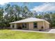 Charming single-story home with green framed windows, metal roof, and a well-maintained lawn at 723 River Run Rd, Osteen, FL 32764