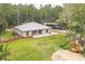 Spacious single-story home featuring lush green lawn, mature trees, and a metal roof at 723 River Run Rd, Osteen, FL 32764