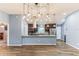 Open concept kitchen boasts granite countertops, stainless appliances, and modern lighting at 723 River Run Rd, Osteen, FL 32764