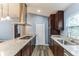 Island kitchen boasts granite countertops and stainless steel range, microwave, and dishwasher at 723 River Run Rd, Osteen, FL 32764