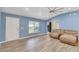 Spacious living room with vaulted ceiling, wood-look tile flooring, and lots of natural light at 723 River Run Rd, Osteen, FL 32764