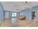 Bright, open living room featuring a vaulted ceiling, wood-look tile flooring, and recessed lighting at 723 River Run Rd, Osteen, FL 32764