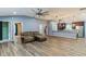 Open-concept living room featuring wood-look tile floors, modern lighting and neutral paint at 723 River Run Rd, Osteen, FL 32764
