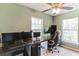 Bright home office featuring a large built-in desk and two windows for natural light at 723 River Run Rd, Osteen, FL 32764