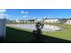 Backyard with a view of a pond and green space, offering a serene and peaceful setting at 741 Spring Palms Loop, Orlando, FL 32828