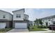 Modern townhome with a two-car garage and stylish gray and white exterior in a well-maintained community at 741 Spring Palms Loop, Orlando, FL 32828