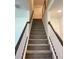 Carpeted staircase with white railings and dark wood accents leading to the upper level at 741 Spring Palms Loop, Orlando, FL 32828