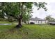 Large grassy backyard featuring mature trees, perfect for outdoor activities and relaxation at 789 Barger Dr, Deltona, FL 32738
