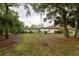 Large, private backyard surrounded by mature trees and lush greenery, creating a serene and secluded oasis at 789 Barger Dr, Deltona, FL 32738
