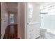 Bright bathroom featuring marble countertop, white cabinetry, and tiled glass shower at 789 Barger Dr, Deltona, FL 32738