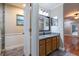 Bathroom featuring granite countertops, stylish mirror, and shower with glass door at 789 Barger Dr, Deltona, FL 32738