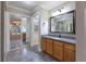 Bathroom featuring granite countertops, stylish mirror, and grey tile flooring at 789 Barger Dr, Deltona, FL 32738