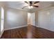 Bedroom with wood floors, a ceiling fan, and a closet with paneled doors at 789 Barger Dr, Deltona, FL 32738