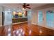 Open-concept space with hardwood floors and a kitchen bar with granite countertops at 789 Barger Dr, Deltona, FL 32738