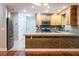 Modern kitchen with granite countertops, stainless steel appliances, and stone backsplash, ideal for entertaining at 789 Barger Dr, Deltona, FL 32738