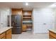 Open-concept kitchen with stainless refrigerator, granite counters, custom cabinets, and spacious design for Gathering gatherings at 789 Barger Dr, Deltona, FL 32738