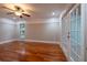 Hardwood floor living room with ceiling fan and access to the yard through french doors at 789 Barger Dr, Deltona, FL 32738