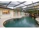 Screened-in pool area featuring lush landscaping and a charming rock waterfall feature at 789 Barger Dr, Deltona, FL 32738