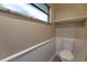 Half bathroom with a modern toilet, wainscotting, and a window above at 789 Barger Dr, Deltona, FL 32738