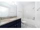 Bathroom featuring granite countertops and modern fixtures, complemented by a tiled tub and shower at 7931 Rock Dove Dr, Winter Garden, FL 34787