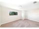 This bedroom has neutral walls and carpet along with a window and closet at 7931 Rock Dove Dr, Winter Garden, FL 34787