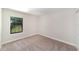 This bedroom has neutral walls and carpet along with a window at 7931 Rock Dove Dr, Winter Garden, FL 34787