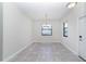 Bright dining room with two windows and a white door at 7931 Rock Dove Dr, Winter Garden, FL 34787