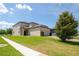 Attractive home with manicured lawn, a two-car garage and brick paver driveway at 7931 Rock Dove Dr, Winter Garden, FL 34787