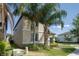 Corner lot featuring verdant lawn, complemented by tropical palms, and attractive exterior details at 7931 Rock Dove Dr, Winter Garden, FL 34787