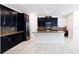Stylish kitchen featuring stainless steel appliances, dark cabinets, and a center island with seating at 7931 Rock Dove Dr, Winter Garden, FL 34787