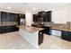 Stylish kitchen featuring stainless steel appliances, dark cabinets, and a center island with seating at 7931 Rock Dove Dr, Winter Garden, FL 34787