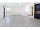 Open living space with tile floors, large windows, and stairway to the second floor at 7931 Rock Dove Dr, Winter Garden, FL 34787