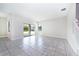 Open living space with tile floors and a sliding door leading to the outdoors at 7931 Rock Dove Dr, Winter Garden, FL 34787