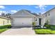 Charming single-Gathering home featuring a two-car garage, manicured lawn, and inviting curb appeal at 805 Ambleside Dr, Haines City, FL 33844