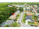 Aerial view of a suburban home featuring mature landscaping, a quiet street, and access to a community lake at 812 Silverwood Dr, Lake Mary, FL 32746