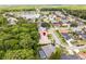 An aerial view shows a home with mature trees, landscaping, and a backyard pool in a residential community at 812 Silverwood Dr, Lake Mary, FL 32746