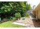 Lush backyard features a landscaped patio, gravel area, and partial view of the pool at 812 Silverwood Dr, Lake Mary, FL 32746