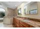 Bathroom with granite counters, wood cabinets, double sinks, soaking tub and shower at 812 Silverwood Dr, Lake Mary, FL 32746