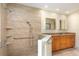 Bathroom with double sinks, wood cabinets, walk-in shower with grab bars at 812 Silverwood Dr, Lake Mary, FL 32746