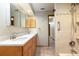 Bathroom with dual sinks, wood cabinets, and walk-in shower at 812 Silverwood Dr, Lake Mary, FL 32746