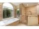 Bathroom featuring a soaking tub under large window, and tiled walk-in shower at 812 Silverwood Dr, Lake Mary, FL 32746